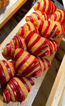 Close up of group of fresh baked delicious christmas croissants, super delicious warm fresh buttery Croissants and Rolls, French and American Croissants and baked pastries are enjoyed world wide on bakery shop, tasty multiple croissant