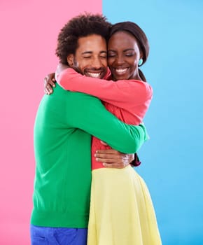 Hug, love and black couple with marriage, excited and romance on colourful studio background. Relationship, embrace and man with woman or expression with emotion or bonding together with date or care.