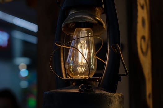 Retro kerosene lamp glows in the dark close up