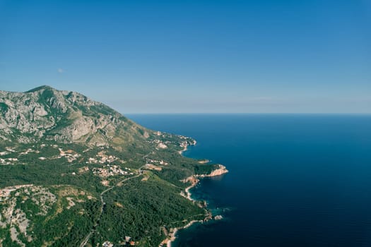 Mountain highway on a slope above a blue bay. Montenegro. Drone. High quality photo