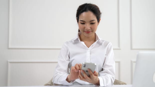 Young woman using smartphone browsing for online shopping E commerce by online payment gateway at vivancy home. Modern and convenience online purchasing make secure and convenient purchases.