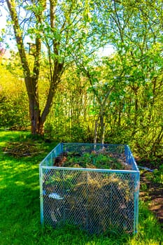 Green Garden with trees plants hut compost beds lawn and barbecue area in Leherheide Bremerhaven Bremen Germany.