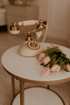 rare phone exquisite vintage decorated with gold fresh pastel flowers tulips. furniture, design solutions. details in interior decoration for home.holiday March 8, International Women Day, gift