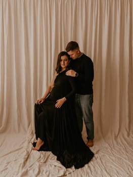 an incredibly beautiful married couple Expecting child, pregnant wife. Happy parenthood, real Ukrainian young family. romantic, gentle, stylish photo session of married couple. pregnant woman in love