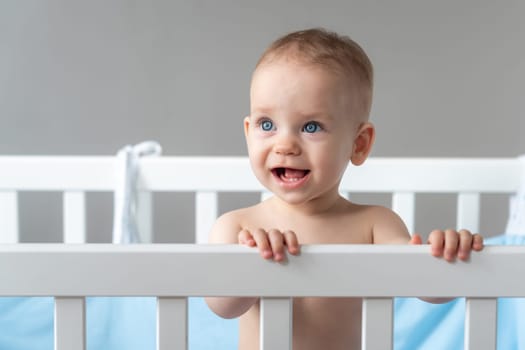 The baby stares with his mouth open in surprise.