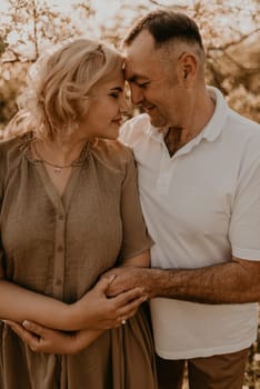 happy married couple mature people together for long time, secret of strong family relationships, cheerful joyful husband and wife together in harmony. middle-aged couple walking in nature at summer