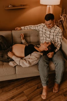 an incredibly beautiful married couple Expecting child, pregnant wife. Happy parenthood, real Ukrainian young family. romantic, gentle, stylish photo session of married couple. pregnant woman in love