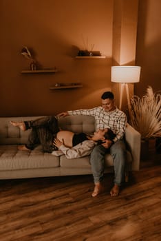 an incredibly beautiful married couple Expecting child, pregnant wife. Happy parenthood, real Ukrainian young family. romantic, gentle, stylish photo session of married couple. pregnant woman in love