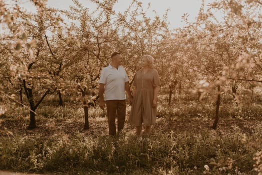 happy married couple mature people together for long time, secret of strong family relationships, cheerful joyful husband and wife together in harmony. middle-aged couple walking in nature at summer