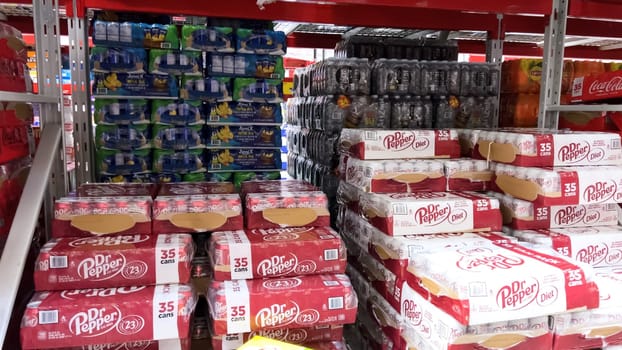 Denver, Colorado, USA-February 28, 2024-At Sam’s Club, the shelves are stocked with bulk multipacks of Coca-Cola Original Taste, their iconic red branding a familiar sight, ready for members to enjoy the classic flavor.