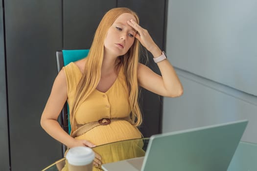 Tired pregnant woman at work drinks coffee. caution advised due to potential harm of caffeine during pregnancy.