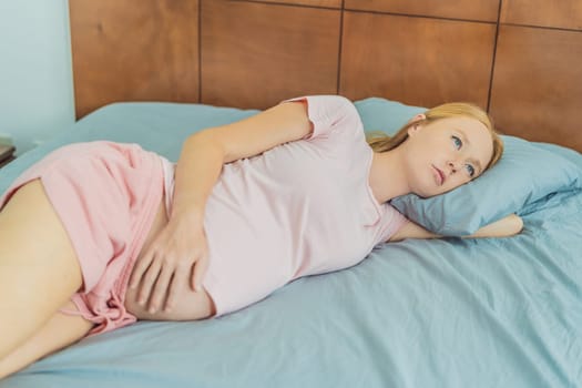 Sleep-deprived pregnant woman struggles with insomnia, navigating the challenges of restlessness during pregnancy.