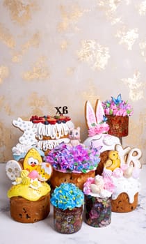 A variety of Easter cakes with intricate icing decorations, featuring bunnies, chicks, flowers, and butterflies. Perfect for a festive Easter celebration. Isolated on a beige background.