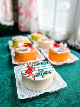 A round white cake with red and blue icing that says 1 September Knowledge Day. The cake is decorated with strawberries, blueberries, and whipped cream. Isolated on a white background.