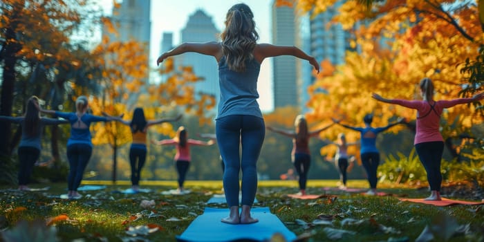 Group of adults attending a yoga class outside in park with natural background.