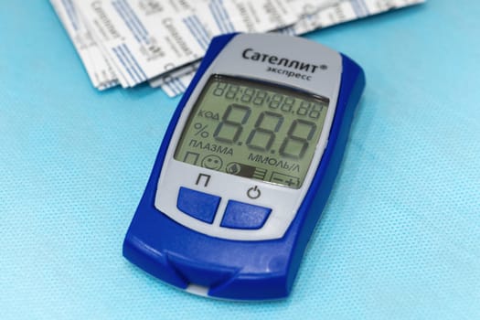 Russian Glucometer Satellite Express: medical device for quick test, sugar diabetes monitoring, measuring checking blood sugar in diabetes mellitus. Close-up view. Kamchatka, Russia - October 17, 2019