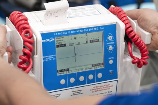 Doctor controls Russian portable defibrillator monitor Axion DKI-N-10 is used in medical hospitals, cardiological dispensaries, emergency and emergency medical teams. Kamchatka, Russia - Oct 17, 2019