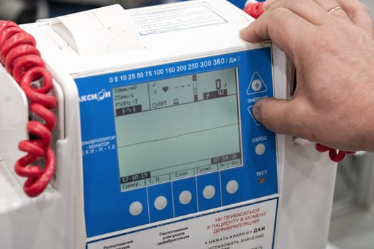 Doctor controls Russian defibrillator monitor Axion DKI-N-10 is used in medical hospitals, cardiological dispensaries, to equip emergency and emergency medical teams. Kamchatka, Russia - Oct 17, 2019
