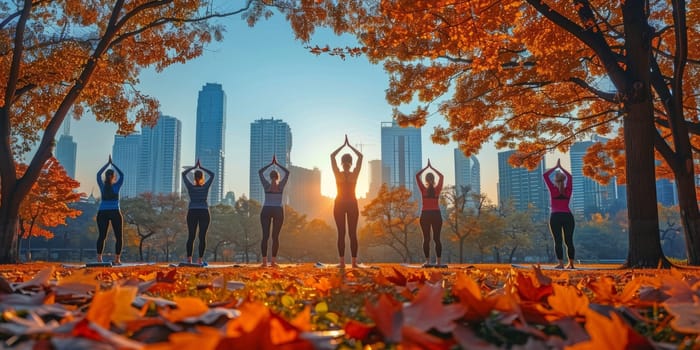 Group of adults attending a yoga class outside in park with natural background.