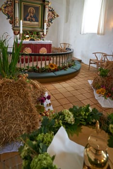 Christian, shrine or altar in church for religion, worship and spiritual festival or ceremony in Danish culture. Praise, god and painting of Jesus in chapel interior with flowers and holy decoration.