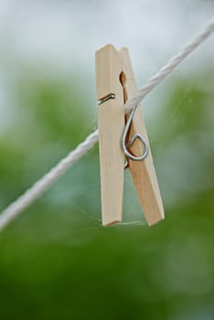 Peg, rope and outdoor for clothes from laundry, clean and dry in nature with plastic clip of closeup. Washing, empty line and wooden tool to hang or pin cloth on wire, fasten and backyard AT house.