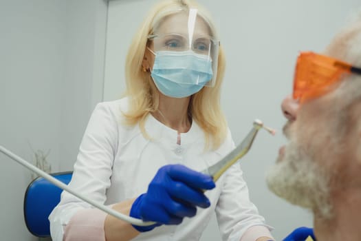 Male smiling during her dental treatment at dentist.