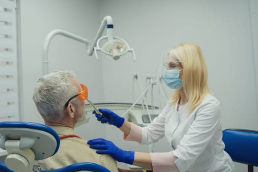 Male smiling during her dental treatment at dentist.