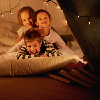 Love, children and portrait of siblings in a bed with fun, support and trust while bonding at home together. Family, night and face of kids in a bedroom for evening games, playing or indoor camping.