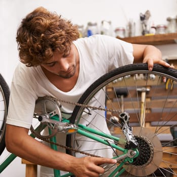 Handyman, fixing and bicycles with with tools at workshop for repair, maintenance with small business. Mechanic, Entrepreneur and garage as expert for bike with equipment for service and upgrade.