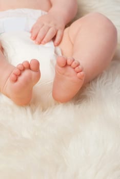 Baby feet, cute and toes in bedroom, blanket and playtime in diaper for child development in skin care. Infant, kid and wellness for newborn, adorable and rug in house for home and toddler fun.
