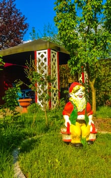 Large colorful garden gnome in the garden on the lawn in Leherheide Bremerhaven Bremen Germany.