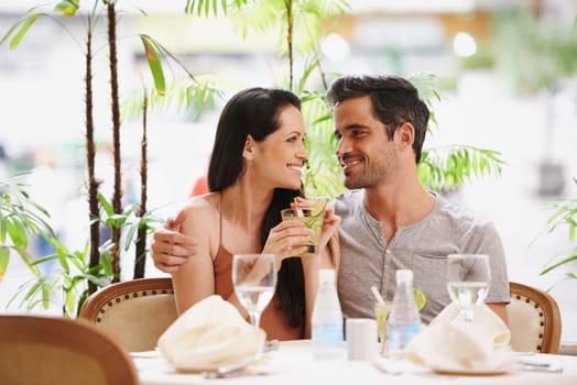 Couple, restaurant and date with love and happy in outdoor with smile, romance and valentines day. Relationship, affection and relax for bonding together with lunch and conversation with support