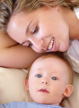 Baby, cute and happy with mother, relaxing and love together with child and care for motherhood. Infant, mom and smile for affection, nurture and home for growth and babysitting with family bonding.