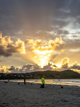 20 man are competing in a fishing competition on the beach