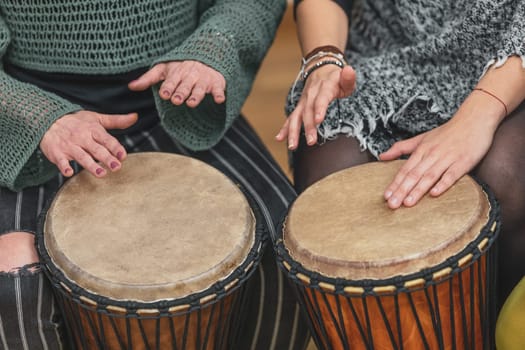 Group of people playing drums during music therapy lessons, jembe drum, drumming concept
