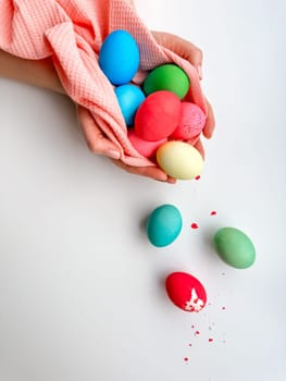 Hands holding colorful painted Easter eggs with one cracked egg on the side, representing Easter festivities, spring celebrations, and family fun activities. High quality photo