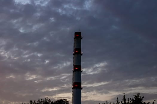 Brick chimney of the factory on the background of the blue sky