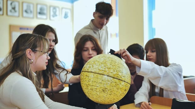 High school students looking at the yellow globe of the moon