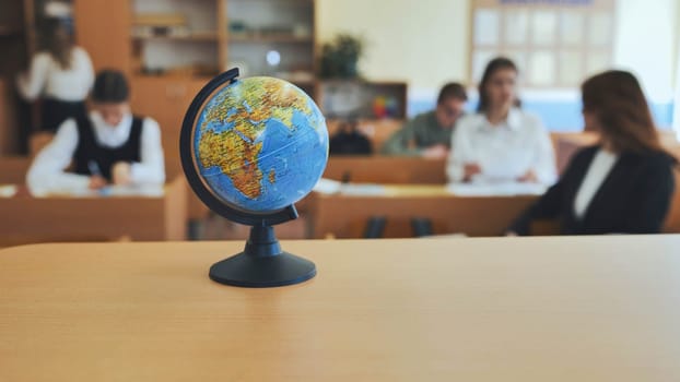 A globe of the world in a school classroom during a lesson