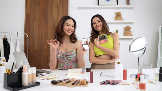 Two influencer partner shoot live streaming vlog video review makeup social media or blog. Happy young girl with vivancy cosmetics studio lighting for marketing recording session broadcasting online.