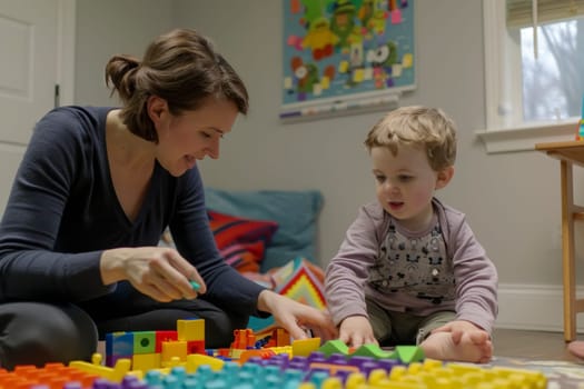 A smiling therapist interacts with a focused child with autism during a playful learning session. The use of colorful building blocks aids in developmental therapy