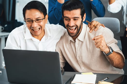 Excited and happy office worker employee celebrate after make successful strategic business marketing planning. Teamwork and positive attitude create productive and supportive workplace. Prudent