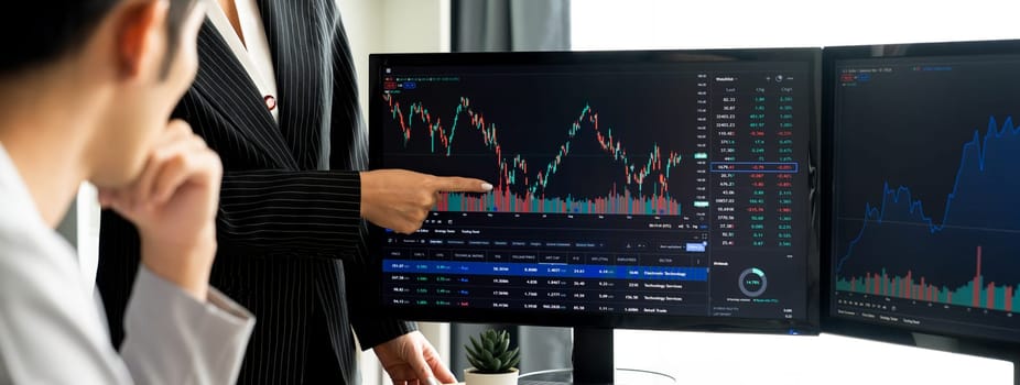 Group of profession trader discuss about stock market investment while point the increasing financial graph displayed on computer. Stock market investment concept Cropped image. Burgeoning.