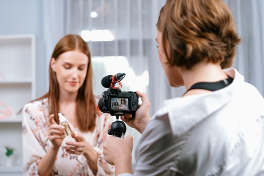 Woman influencer shoot live streaming vlog video review makeup utmost social media or blog. Happy young girl with cosmetics studio lighting for marketing recording session broadcasting online.