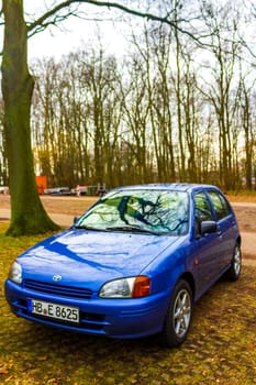 Bremerhaven Bremen Germany 15. March 2011 Small blue car vehicle parked in Speckenbütteler Park Lehe Bremerhaven Bremen Germany.