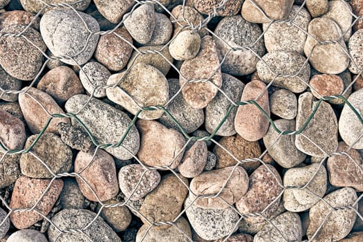 The texture of the rock. Pebble earth and stone for background texture behind bars .