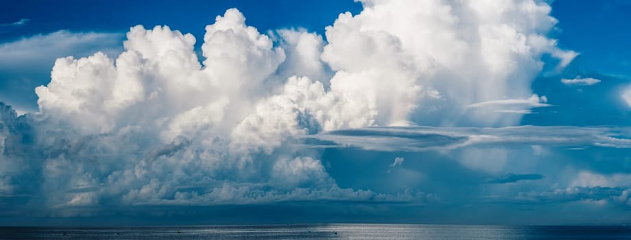 Seascape nature beauty, magic huge cumulus white clouds over blue sea, freedom happiness opportunity.