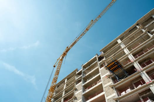 Construction crane working on large construction site