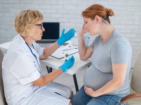 A pregnant woman cries during a doctor's visit. Gestational diabetes