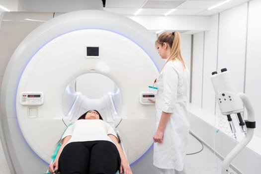 Medical CT or MRI Scan with a patient in the modern hospital laboratory. Interior of radiography department. Technologically advanced equipment in white room. Magnetic resonance diagnostics machine.